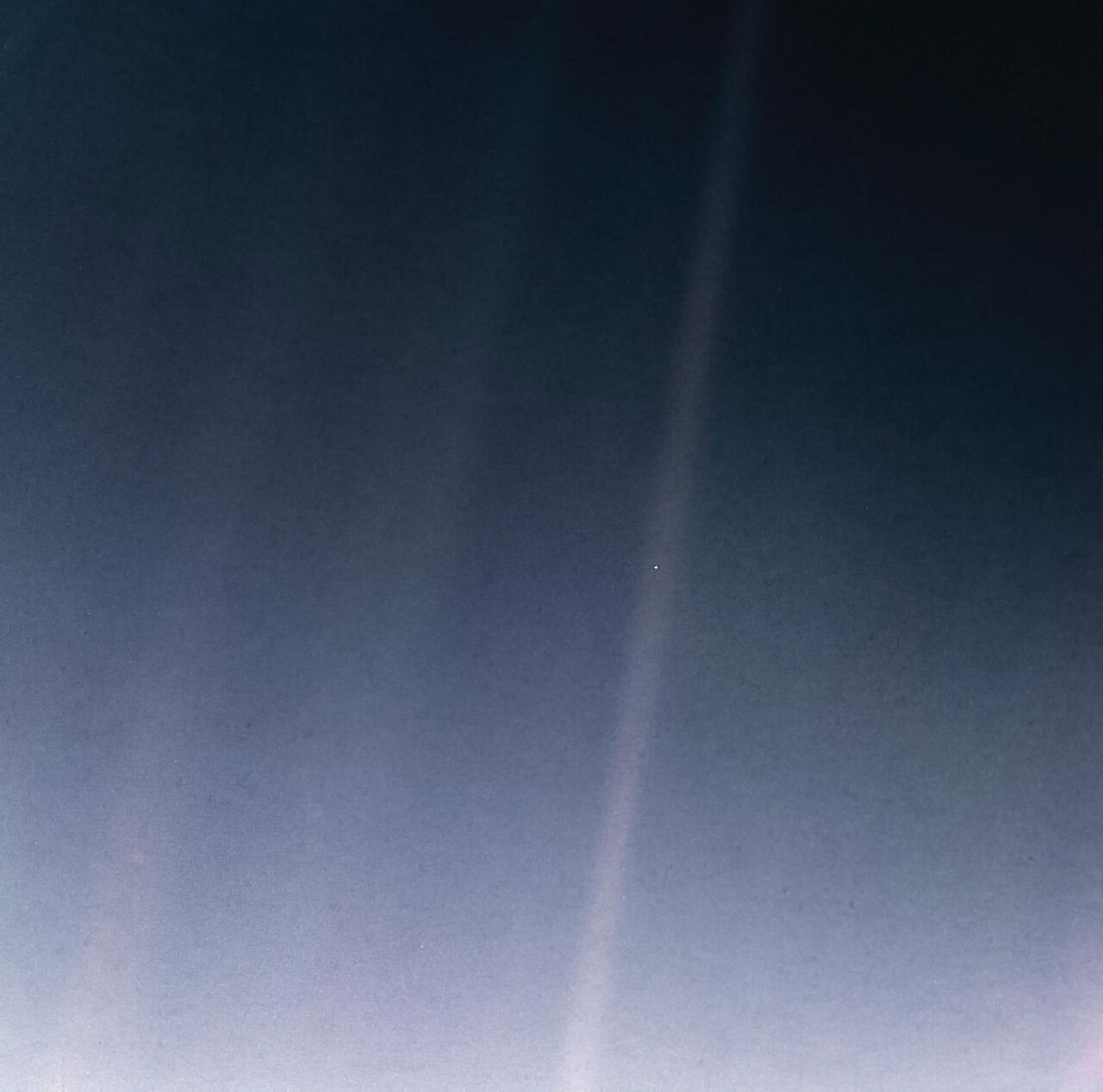 A pale speck of Earth in a sunbeam, photographed by Voyager 1