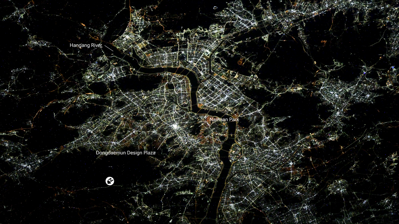 Seoul at night, the Han River a dark line through the city lights